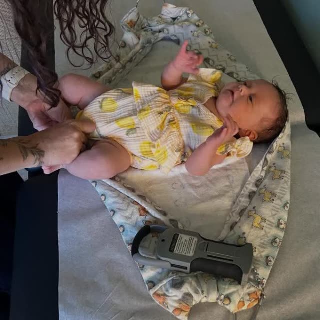 A smiling baby on the adjustment table